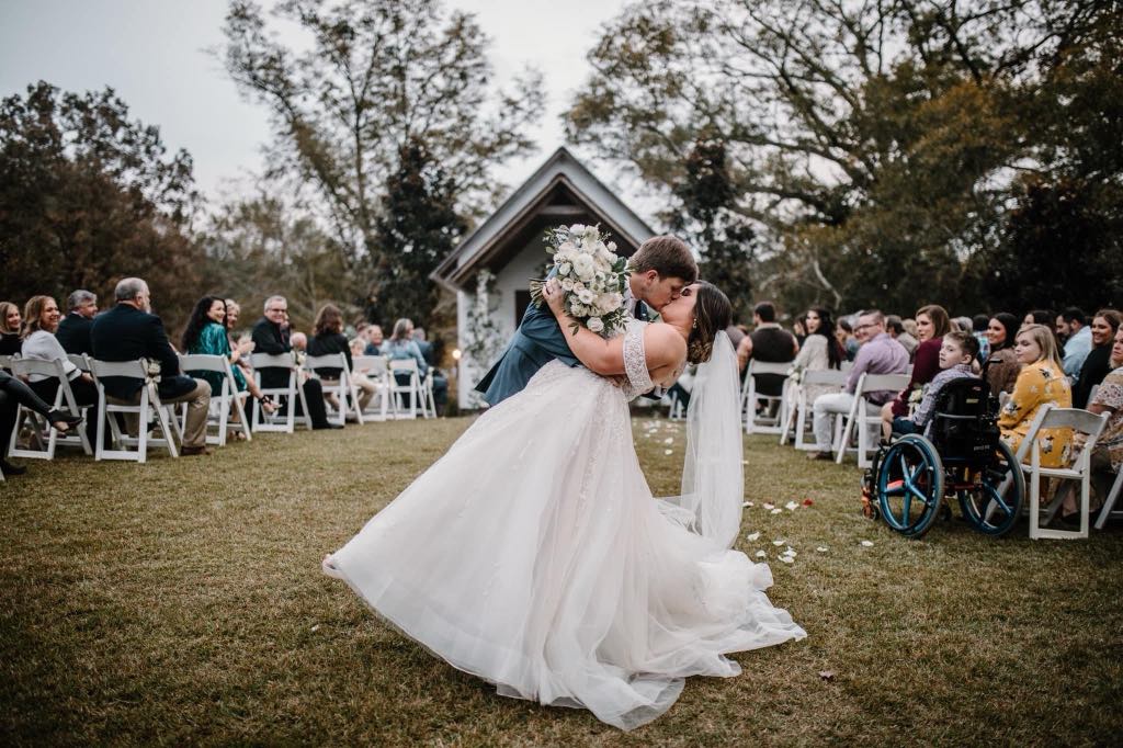 Bride walking down the outdoor ceremony aisle at Chapelwoods Venue