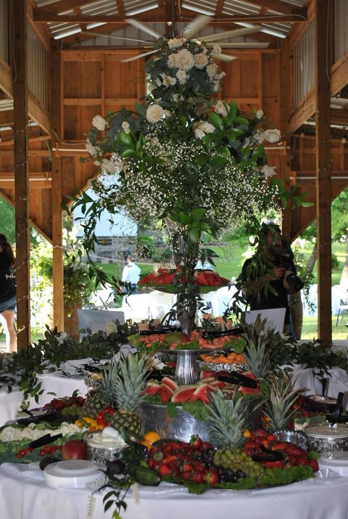 Wedding reception table set with greenery and warm lights